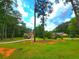 Two-story home featuring an expansive front yard, lush greenery, and ample space at 4086 Rex Road, Rex, GA 30273