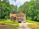 Traditional two-story home with black shutters, a brick chimney and luscious green lawn at 4086 Rex Road, Rex, GA 30273