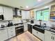 Bright and spacious kitchen featuring granite countertops, stainless steel appliances, and custom cabinetry at 4086 Rex Road, Rex, GA 30273