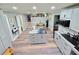 Kitchen with island featuring granite countertop, stainless steel appliances and seamlessly connecting to the dining area at 4086 Rex Road, Rex, GA 30273