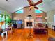 Inviting living room featuring hardwood floors, a cozy fireplace, and a vaulted ceiling with fan at 4086 Rex Road, Rex, GA 30273