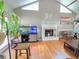 Bright living room showcasing hardwood floors, a fireplace, and a vaulted ceiling with fan at 4086 Rex Road, Rex, GA 30273