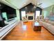 Comfortable living room featuring hardwood floors, a fireplace, and vaulted ceiling at 4086 Rex Road, Rex, GA 30273