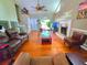 Cozy living room with hardwood floors, a fireplace, ceiling fan, and a view to the entryway at 4086 Rex Road, Rex, GA 30273