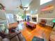 Well-lit living room showcasing hardwood floors, a fireplace, a ceiling fan, and plenty of natural light at 4086 Rex Road, Rex, GA 30273