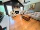 Comfortable living room featuring hardwood floors, a fireplace, and neutral decor at 4086 Rex Road, Rex, GA 30273