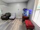 Living room featuring modern wood-look flooring, seating, and aquarium at 4086 Rex Road, Rex, GA 30273