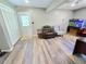 Living room featuring modern wood-look flooring, seating, and aquarium at 4086 Rex Road, Rex, GA 30273