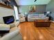 Bright living room featuring hardwood floors, neutral decor, and a modern fireplace at 4086 Rex Road, Rex, GA 30273