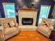 Cozy sitting area showcasing the fireplace, natural light, and hardwood floors at 4086 Rex Road, Rex, GA 30273