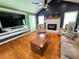 Spacious living room featuring hardwood floors, a fireplace, and a modern television at 4086 Rex Road, Rex, GA 30273