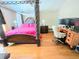 The main bedroom boasts a four poster bed, hardwood flooring, and great natural light at 4086 Rex Road, Rex, GA 30273