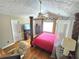 The main bedroom shows off hardwood flooring, a desk, and a four poster bed at 4086 Rex Road, Rex, GA 30273