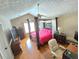 This main bedroom boasts a four poster bed, hardwood flooring, and great natural light at 4086 Rex Road, Rex, GA 30273