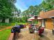 Outdoor patio area with grills, seating and heat lamps perfect for entertaining and relaxing near the backyard trees at 4086 Rex Road, Rex, GA 30273