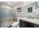 Updated bathroom features a tiled shower with glass door, granite countertop vanity, and modern fixtures at 1315 Merry Ne Ln, Atlanta, GA 30329