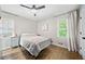 Bright bedroom with hardwood floors, ceiling fan, and a comfortable bed creates an inviting and relaxing space at 1315 Merry Ne Ln, Atlanta, GA 30329