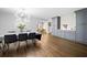 Open dining area featuring hardwood floors, modern chandelier and access to a butler's pantry at 1315 Merry Ne Ln, Atlanta, GA 30329