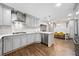 Spacious kitchen featuring modern appliances, sleek countertops, gray cabinets, and hardwood floors at 1315 Merry Ne Ln, Atlanta, GA 30329