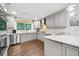 Well-appointed kitchen offers stainless steel appliances, bright countertops, and modern gray cabinetry at 1315 Merry Ne Ln, Atlanta, GA 30329