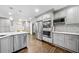 Modern kitchen with stainless steel appliances, sleek gray cabinets, and hardwood flooring at 1315 Merry Ne Ln, Atlanta, GA 30329