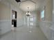 Open concept dining room with elegant chandelier and gleaming tile floors at 1417 Wind Chime Ct, Lawrenceville, GA 30045