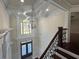 Grand foyer featuring double doors, chandelier, and beautiful staircase with wrought iron railing at 1417 Wind Chime Ct, Lawrenceville, GA 30045