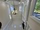 Spacious living room featuring a chandelier and expansive windows for natural light at 1417 Wind Chime Ct, Lawrenceville, GA 30045