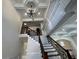 Elegant staircase with wrought iron and coffered ceiling leads to the upper level at 1417 Wind Chime Ct, Lawrenceville, GA 30045