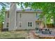 Back of house features large, fenced backyard with a patio area, grill, and picnic table with overhead string lights at 3366 English Oaks Nw Dr, Kennesaw, GA 30144