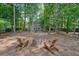 Inviting backyard with a fire pit, wooden chairs, and plenty of space for relaxation at 3366 English Oaks Nw Dr, Kennesaw, GA 30144