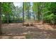 Spacious backyard features a cozy fire pit area with wooden chairs, perfect for outdoor entertaining at 3366 English Oaks Nw Dr, Kennesaw, GA 30144