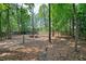 Enjoy this spacious backyard offering a fire pit surrounded by trees, and a private, fenced perimeter at 3366 English Oaks Nw Dr, Kennesaw, GA 30144