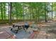 Relax with friends in this backyard featuring a picnic table and grill on a brick patio, surrounded by beautiful greenery at 3366 English Oaks Nw Dr, Kennesaw, GA 30144
