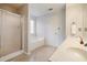Primary bathroom boasts a soaking tub, walk-in shower, dual vanities, and a neutral color palette at 3366 English Oaks Nw Dr, Kennesaw, GA 30144