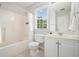 Clean bathroom with tub-shower combo, tile floors, and a window view at 3366 English Oaks Nw Dr, Kennesaw, GA 30144