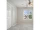 Cozy bedroom with large window, ceiling fan, and soft gray carpet at 3366 English Oaks Nw Dr, Kennesaw, GA 30144