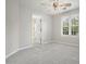 Bright bedroom with a ceiling fan, bathroom access, and view of the backyard at 3366 English Oaks Nw Dr, Kennesaw, GA 30144