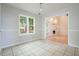 Dining area with tile floors features a view into the living room with fireplace at 3366 English Oaks Nw Dr, Kennesaw, GA 30144