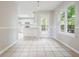 Bright dining area features tile floors, a window, and access to the kitchen at 3366 English Oaks Nw Dr, Kennesaw, GA 30144