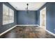 The dining room has slate tile flooring, a modern light fixture, and ample natural light at 3366 English Oaks Nw Dr, Kennesaw, GA 30144