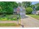 Attractive two-story home with brick detailing, a large driveway, and mature trees at 3366 English Oaks Nw Dr, Kennesaw, GA 30144