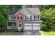 Charming two-story home features a brick facade, two-car garage, and a well-manicured front yard at 3366 English Oaks Nw Dr, Kennesaw, GA 30144