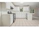 Bright kitchen with white cabinets, tile flooring, and stainless steel appliances at 3366 English Oaks Nw Dr, Kennesaw, GA 30144