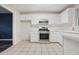 This kitchen boasts white cabinets, modern appliances, and tile flooring at 3366 English Oaks Nw Dr, Kennesaw, GA 30144