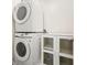 Convenient laundry area with stacked washer and dryer plus storage, maximizing space at 3366 English Oaks Nw Dr, Kennesaw, GA 30144