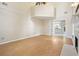 Open living room features a fireplace, view to the kitchen, and light hardwood floors at 3366 English Oaks Nw Dr, Kennesaw, GA 30144