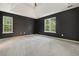 Large main bedroom with neutral carpet, paint, and tray ceiling for added elegance at 3366 English Oaks Nw Dr, Kennesaw, GA 30144