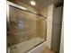 Well-lit bathroom with glass enclosed shower, tile surround, and built-in linen cabinet at 195 14Th Ne St # 303, Atlanta, GA 30309