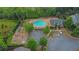 Overhead view of a community pool, playground, parking and trees, enhancing outdoor living at 202 Roseman Way, Woodstock, GA 30188